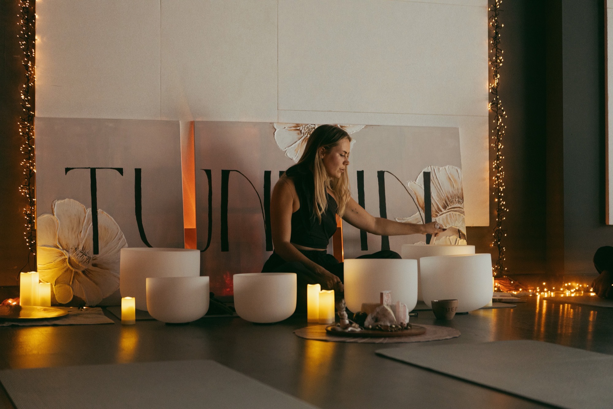The Tune In space set with crystal singing bowls and candles, ready for a private group